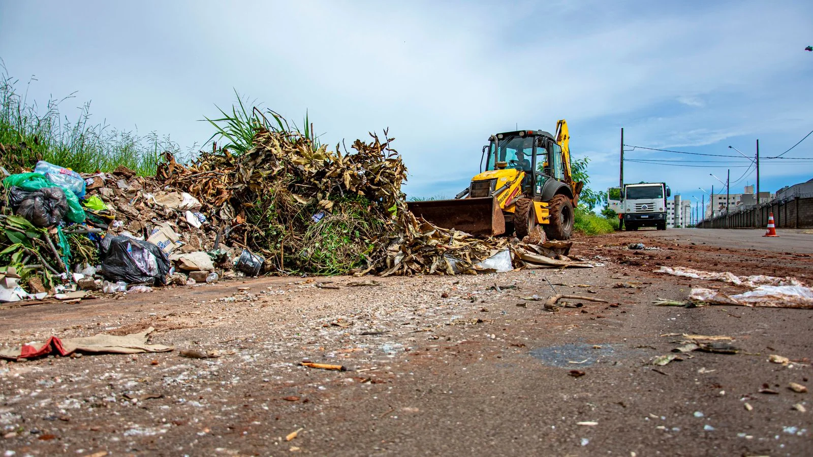 Bulldozer working a debris pile during a street cleanup, the operational reality most haulers never show in public.