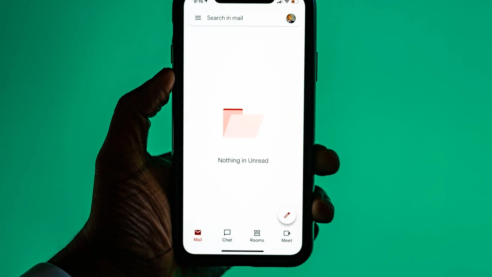 Hand holding a smartphone displaying an email inbox with the latest newsletter from a subscribed founder list