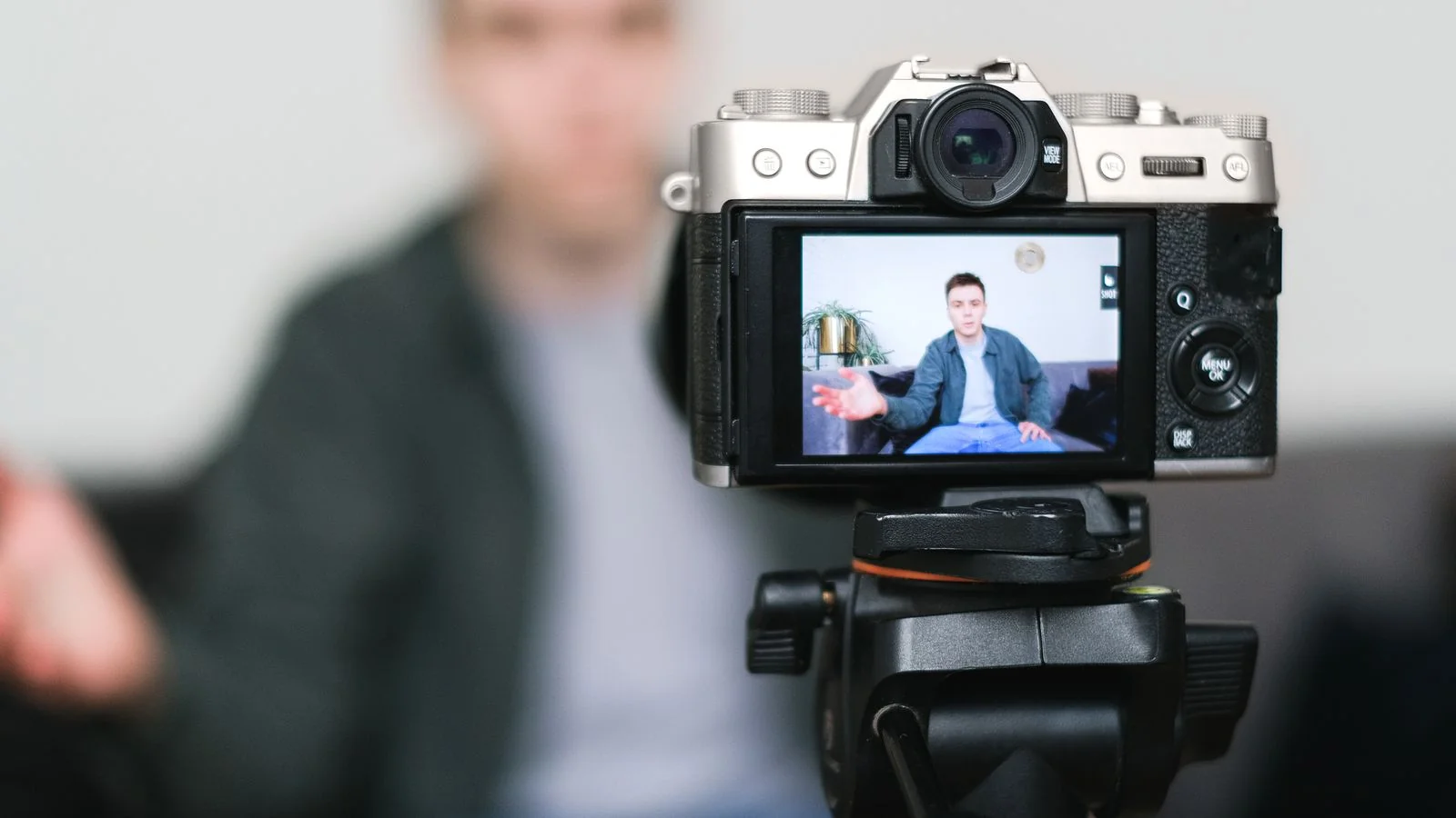 Person filming content with a camera on a tripod, the modern engine of personal-brand thought leadership