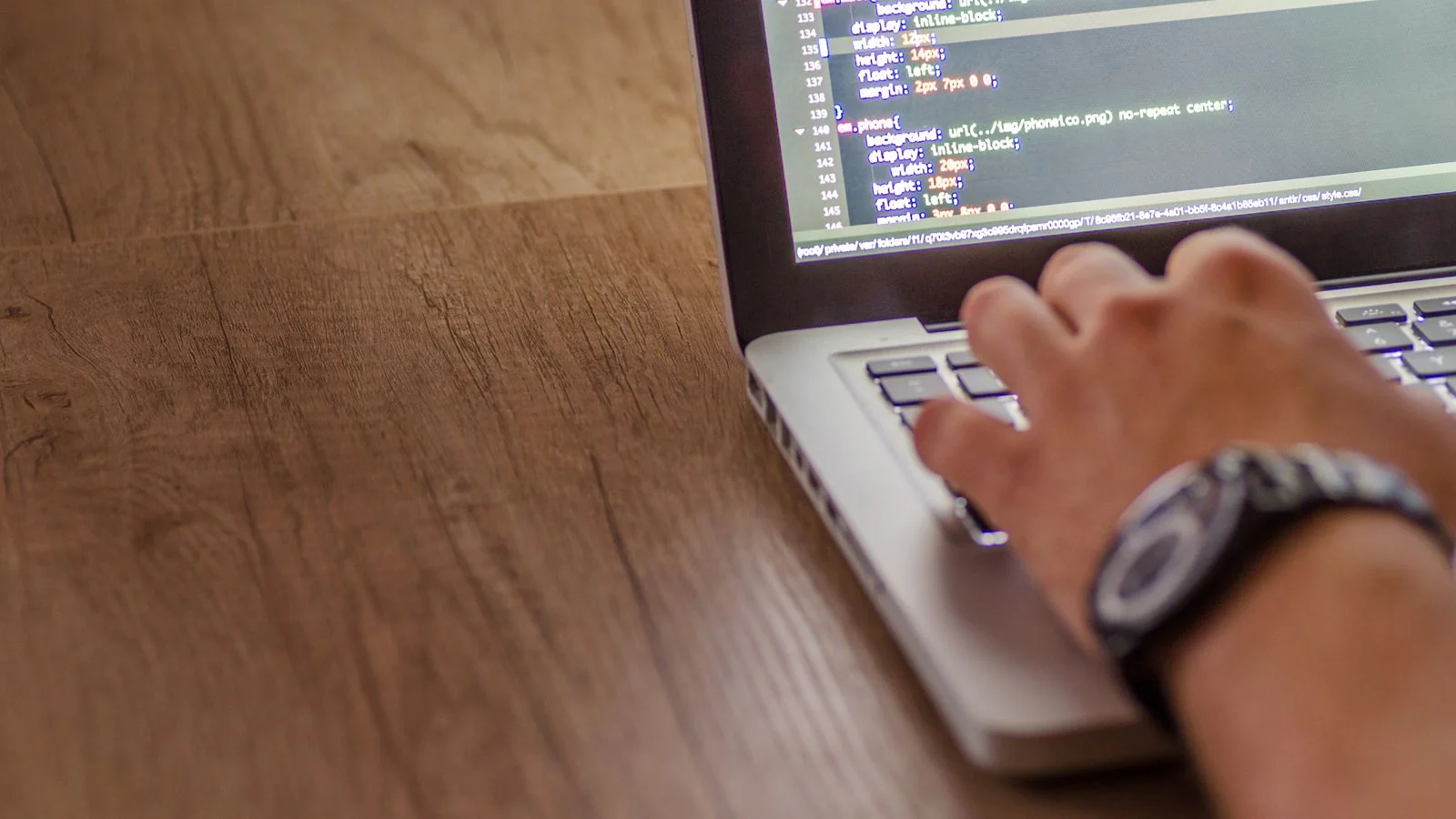A developer coding on a laptop, the work of building on ground you actually control
