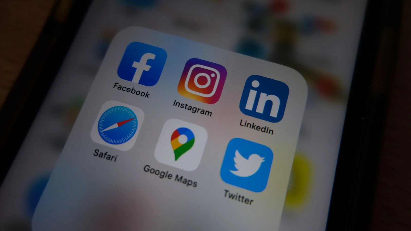 A phone showing app icons including social profiles, the rented platforms a website exists to outlast