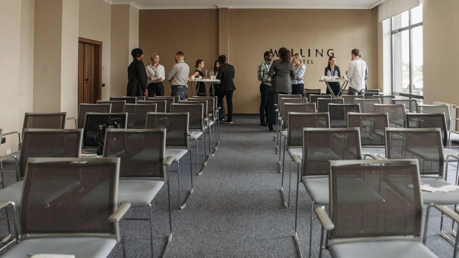 Business professionals shaking hands and networking at a conference, the human side of earned coverage