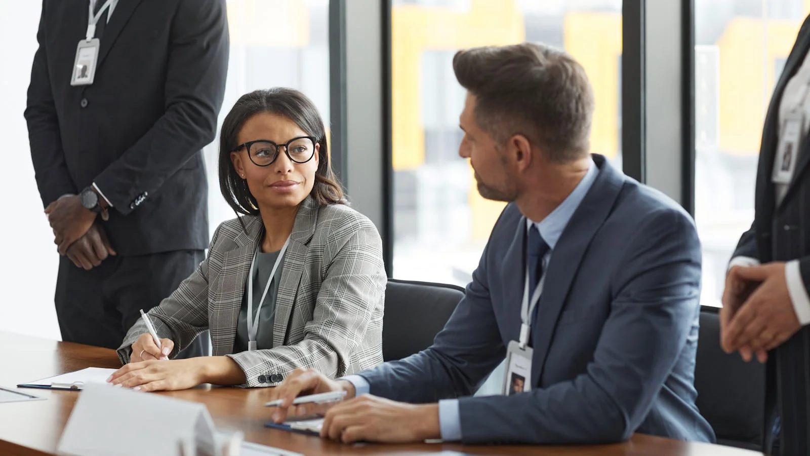 Business professionals in a strategy discussion, the trade-reporter audience a release must be written for
