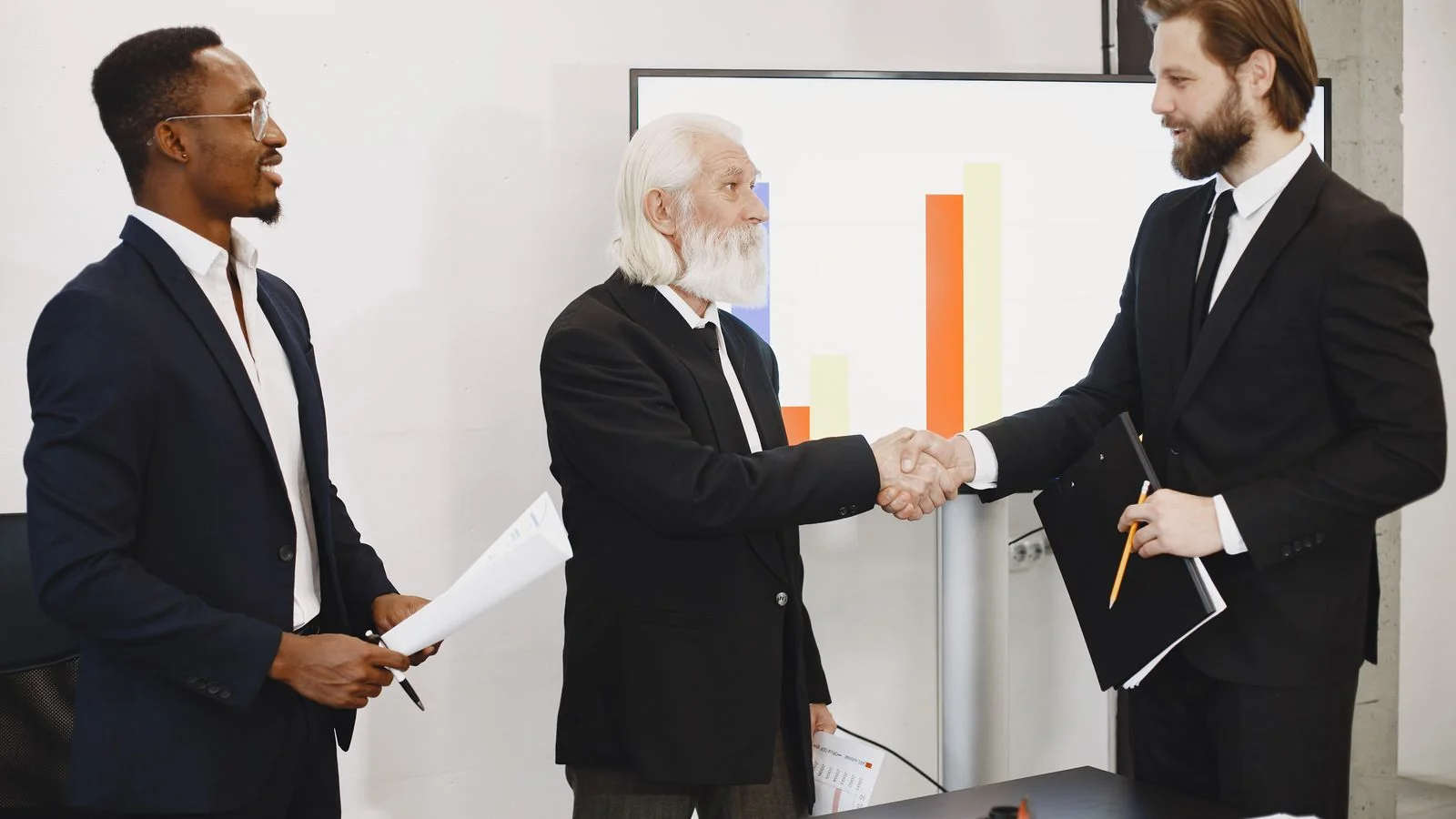 Two business leaders shaking hands over an expansion deal, the human moment a good quote should capture