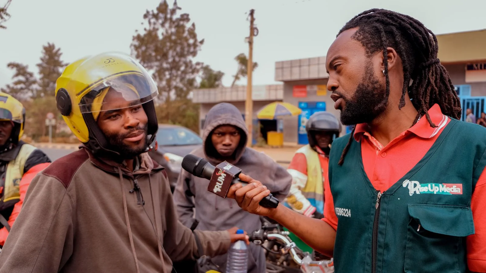 A journalist interviewing people outdoors, the local coverage a well-timed release earns