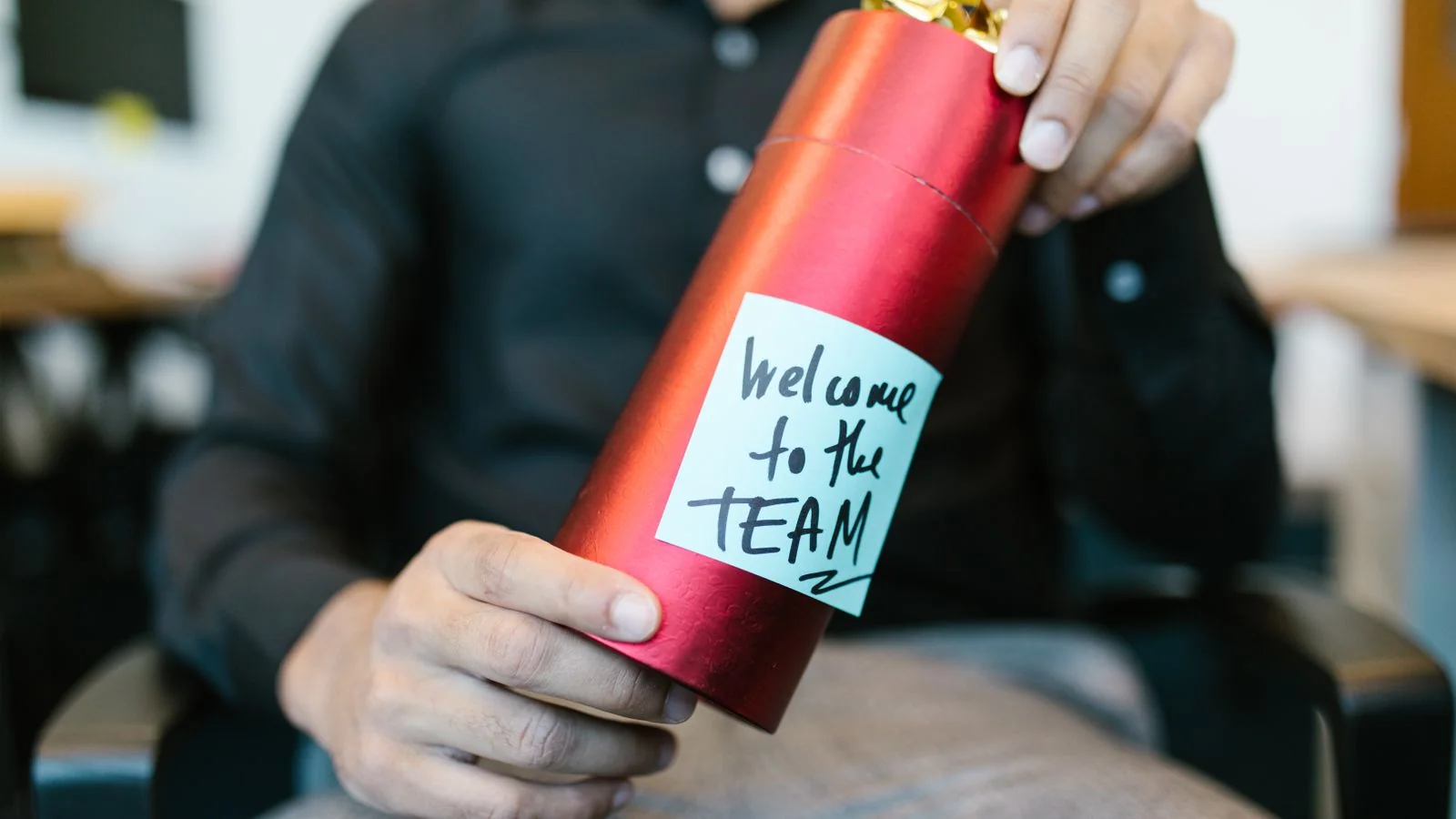 New hire welcomed with a gift and a note, the growth signal a strong announcement sends outward