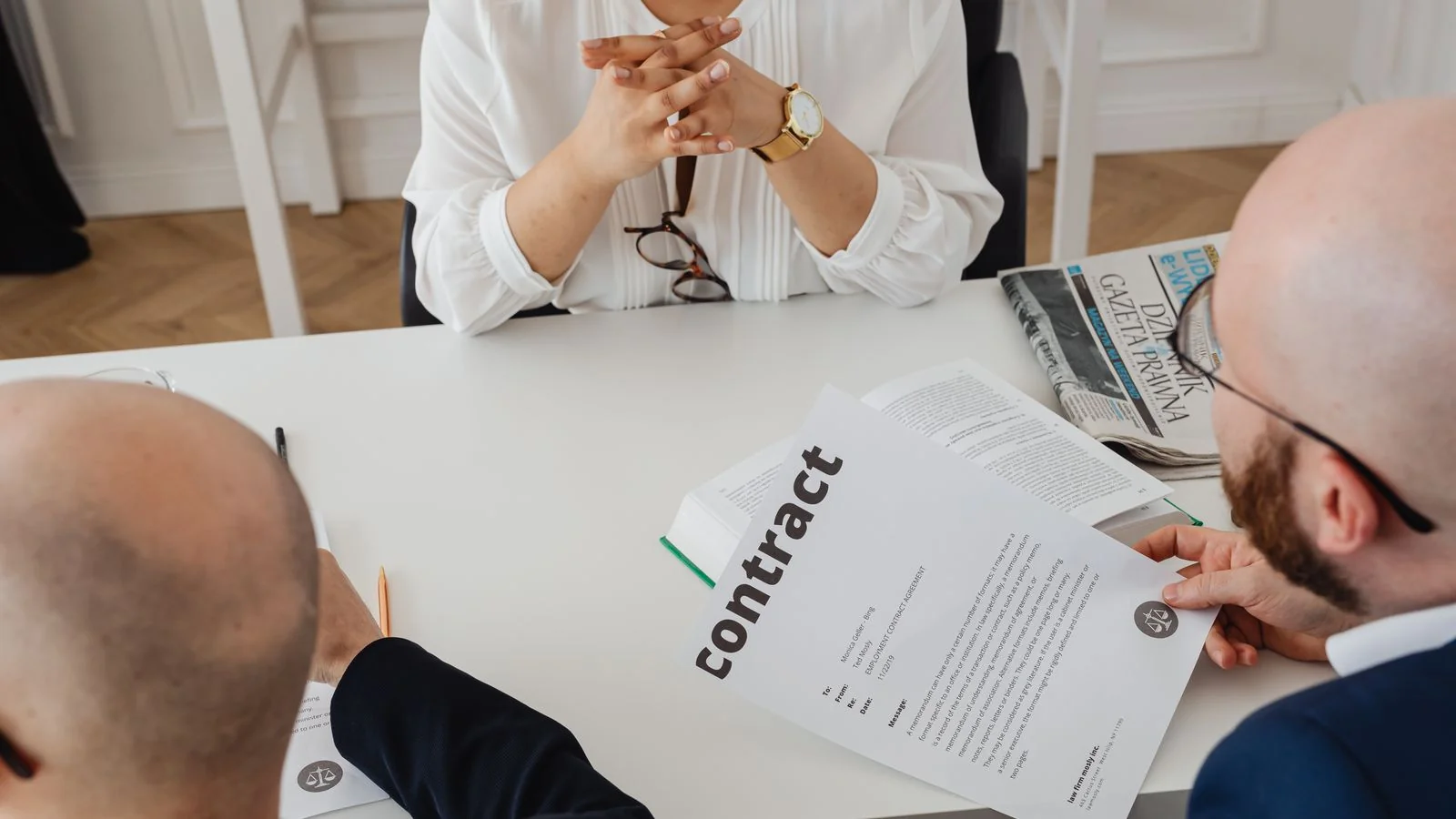 Business partners reviewing a contract together, where joint venture announcements often get stuck.
