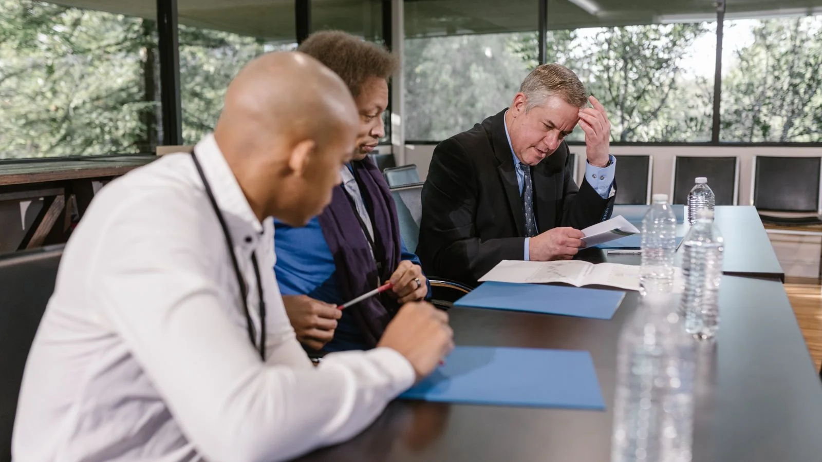 Colleagues reviewing documents in a meeting room, the manager briefings that have to happen before any release