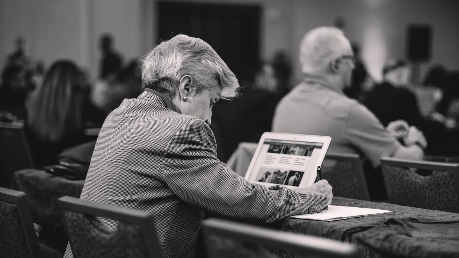 Senior journalist taking notes during a press conference, the kind who will receive your release
