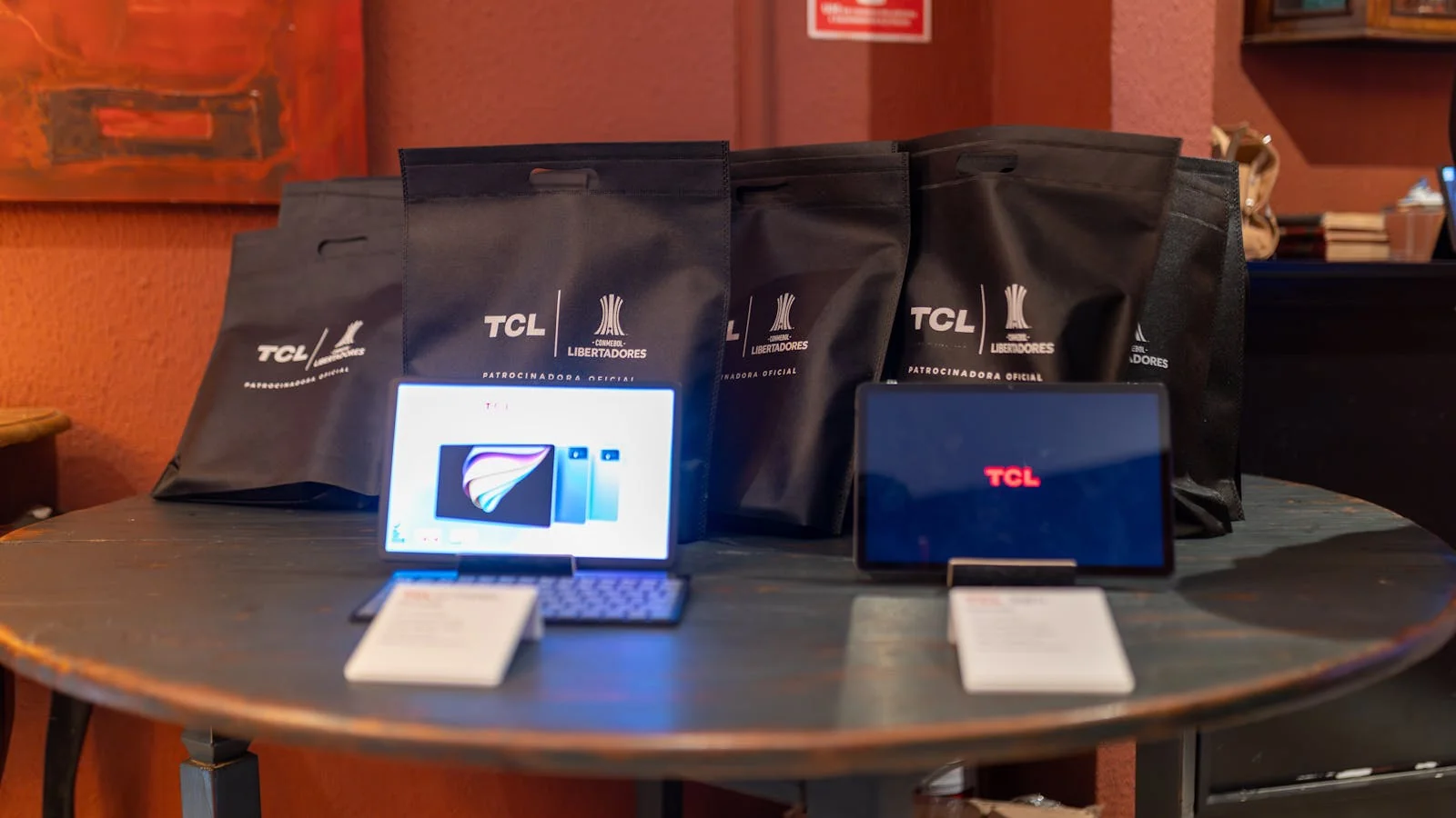 Promotional product setup with tablets and branded materials laid out for a launch event