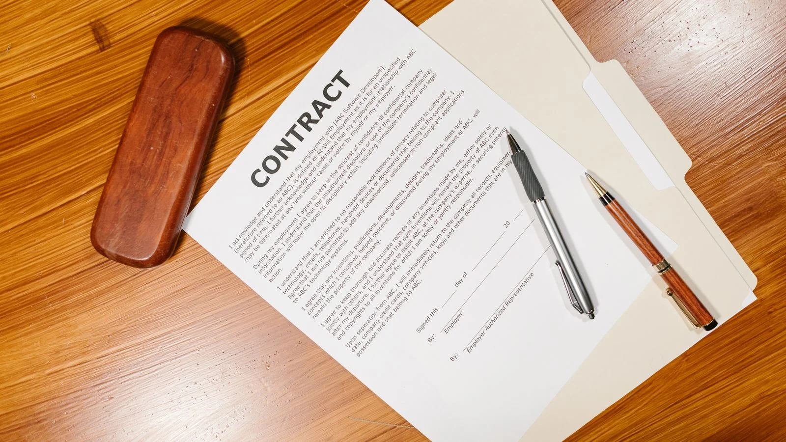 A formal document and pen on a desk, the legal milestone that companies mistake for the whole story
