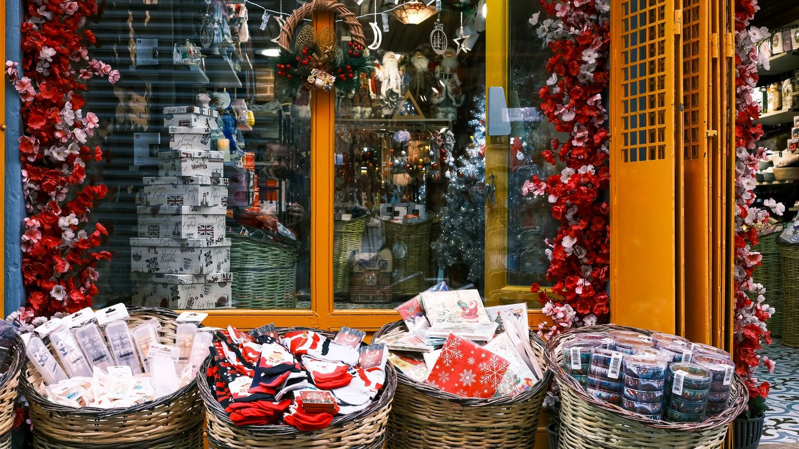 A festive storefront display of wrapped gifts and holiday decorations, the kind of seasonal scene reporters cover