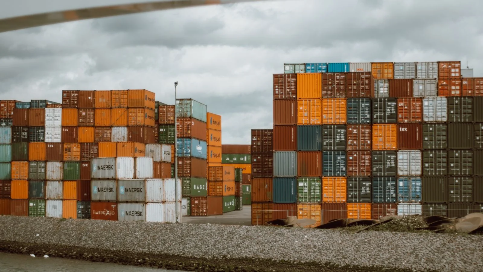 An aerial view of colorful shipping containers stacked in a logistics hub