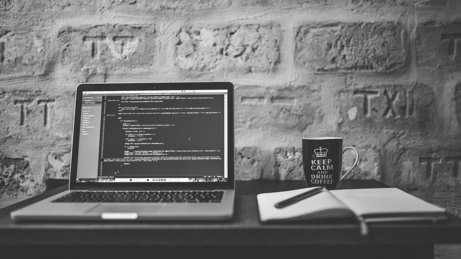 An open laptop and notebook on a clean desk, the setup for writing an owned blog post