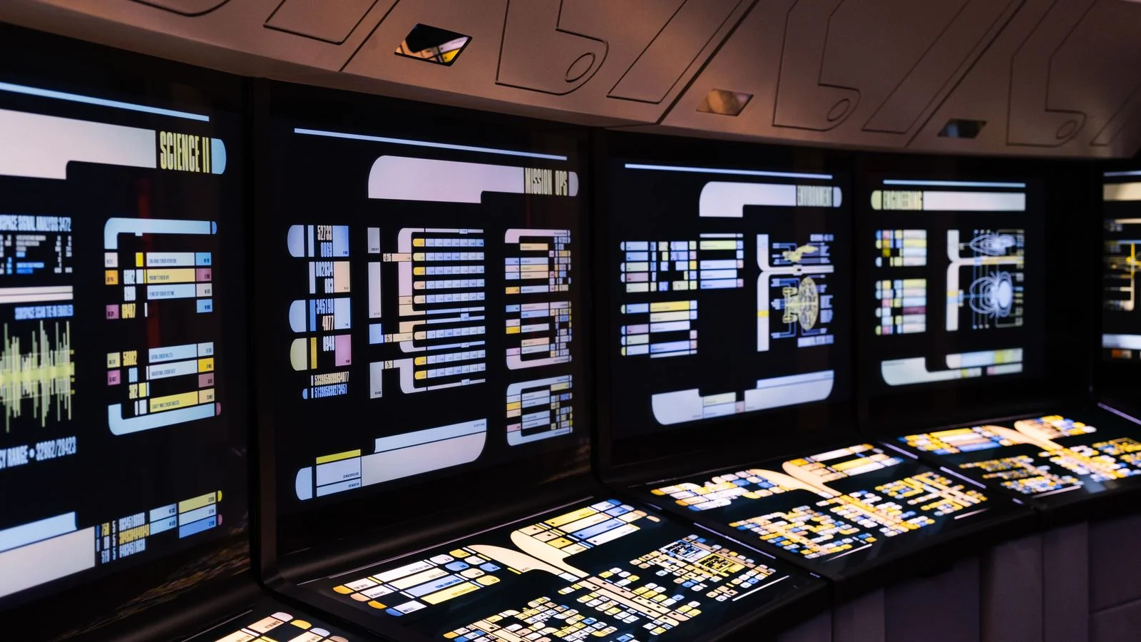 Wall of illuminated screens in a monitoring command centre