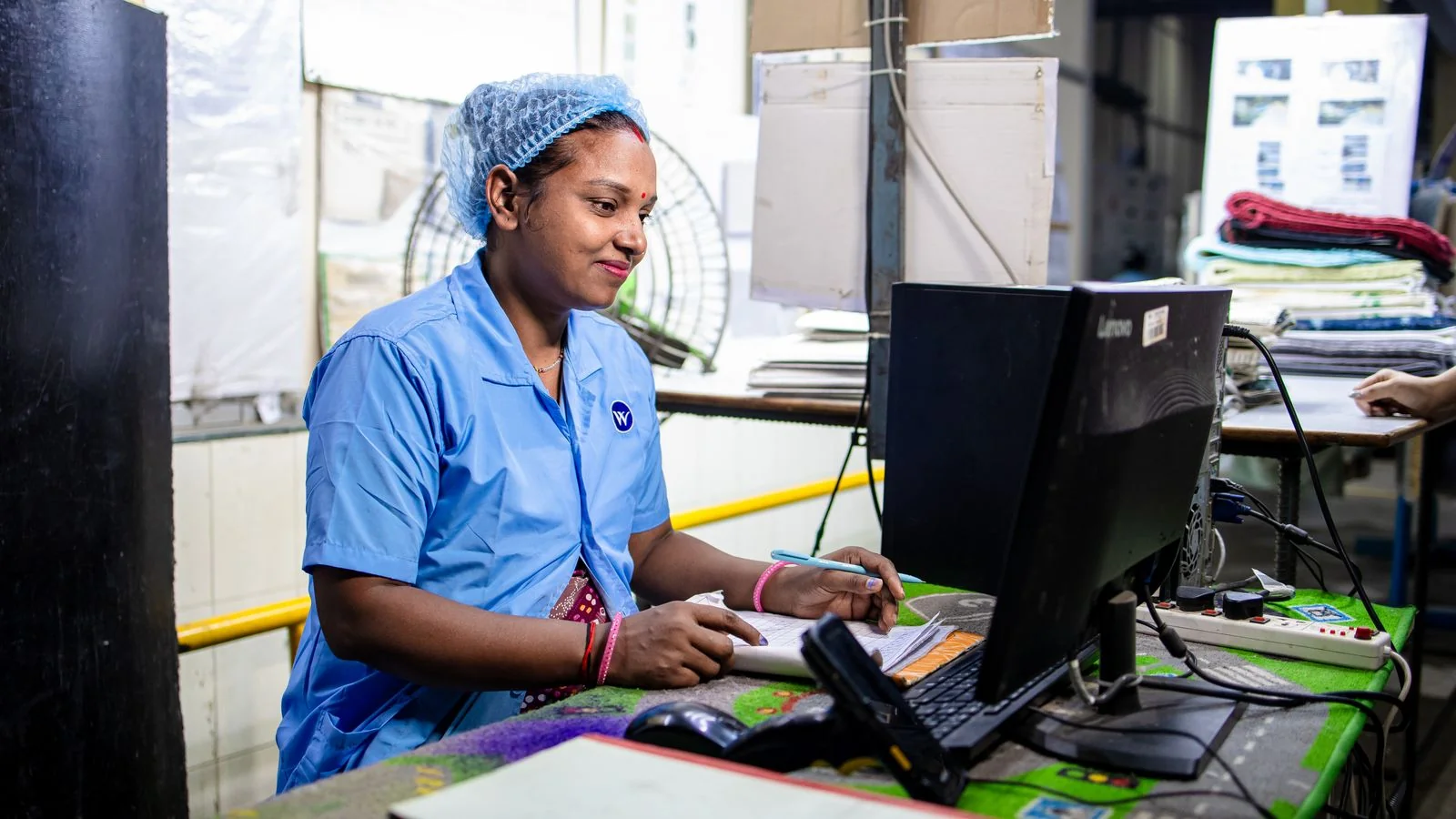 A worker entering data on a factory floor, the automated syndication most wire reports are counting