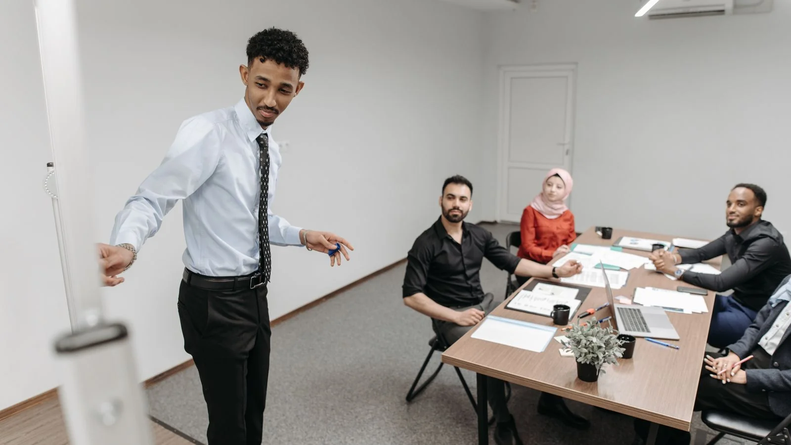 Colleagues gathered in a modern office meeting, the everyday room where most public speaking happens
