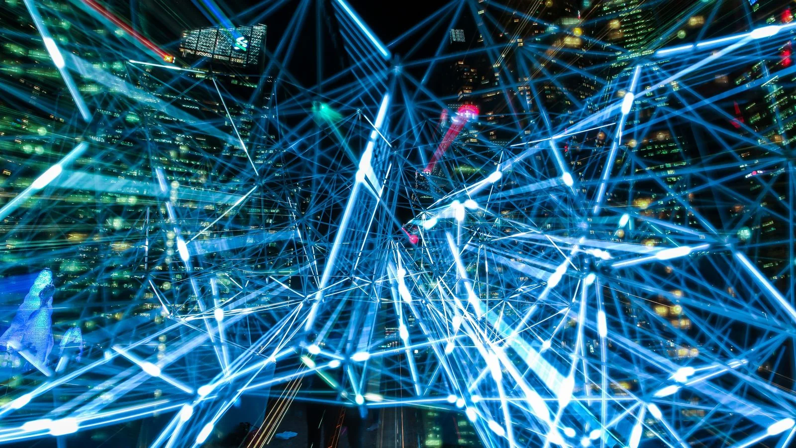 Interconnected light trails branching across a dark field, echoing one question splitting into many searches