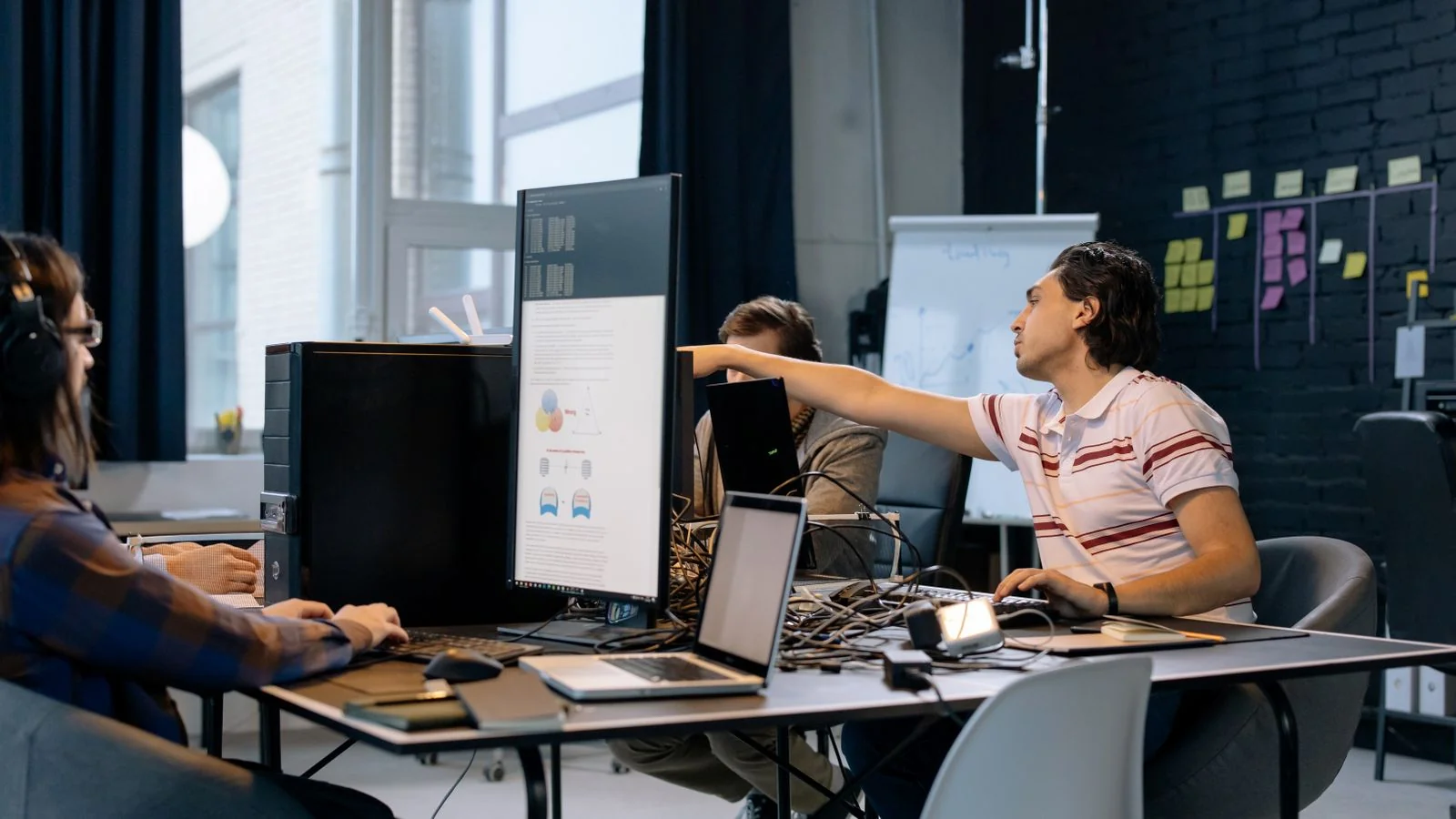Group of young professionals building software together in a creative indoor workspace