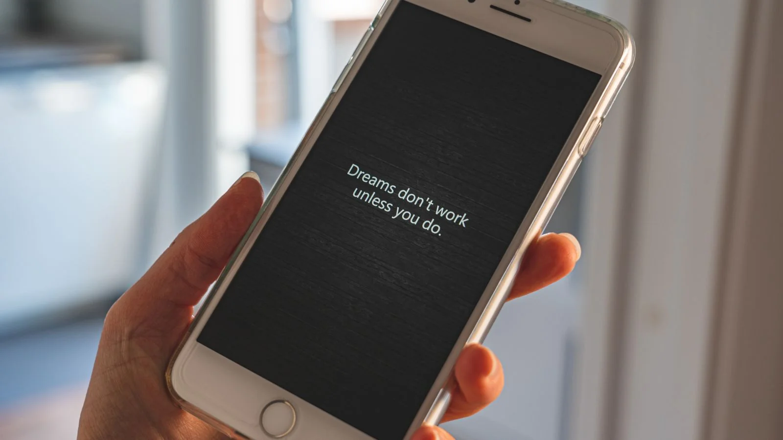 A hand holding a phone mid-scroll, the ten reviews a nervous patient reads before booking