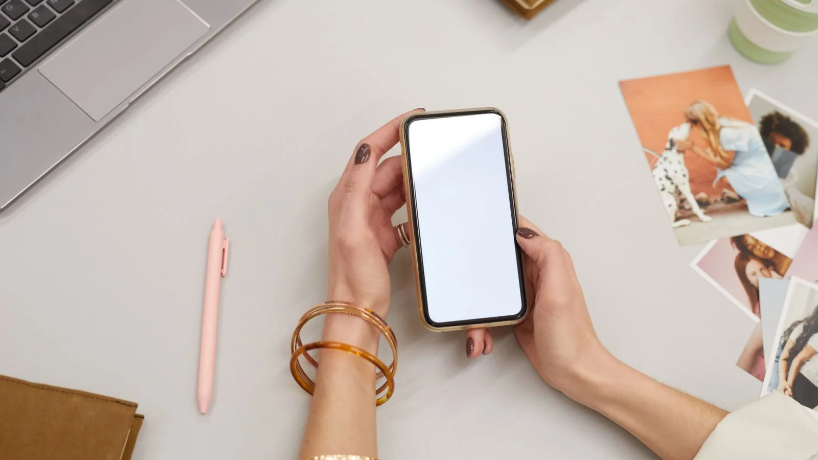 A person checking reviews on a smartphone beside a cup of coffee.
