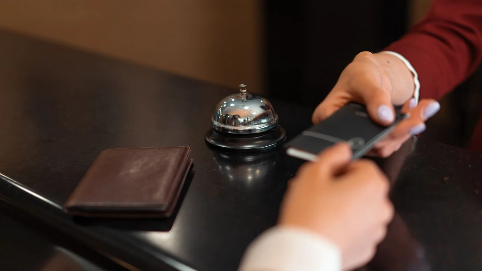 A hotel check-in underway at the reception desk, the moment most guests decide what kind of review they will write.