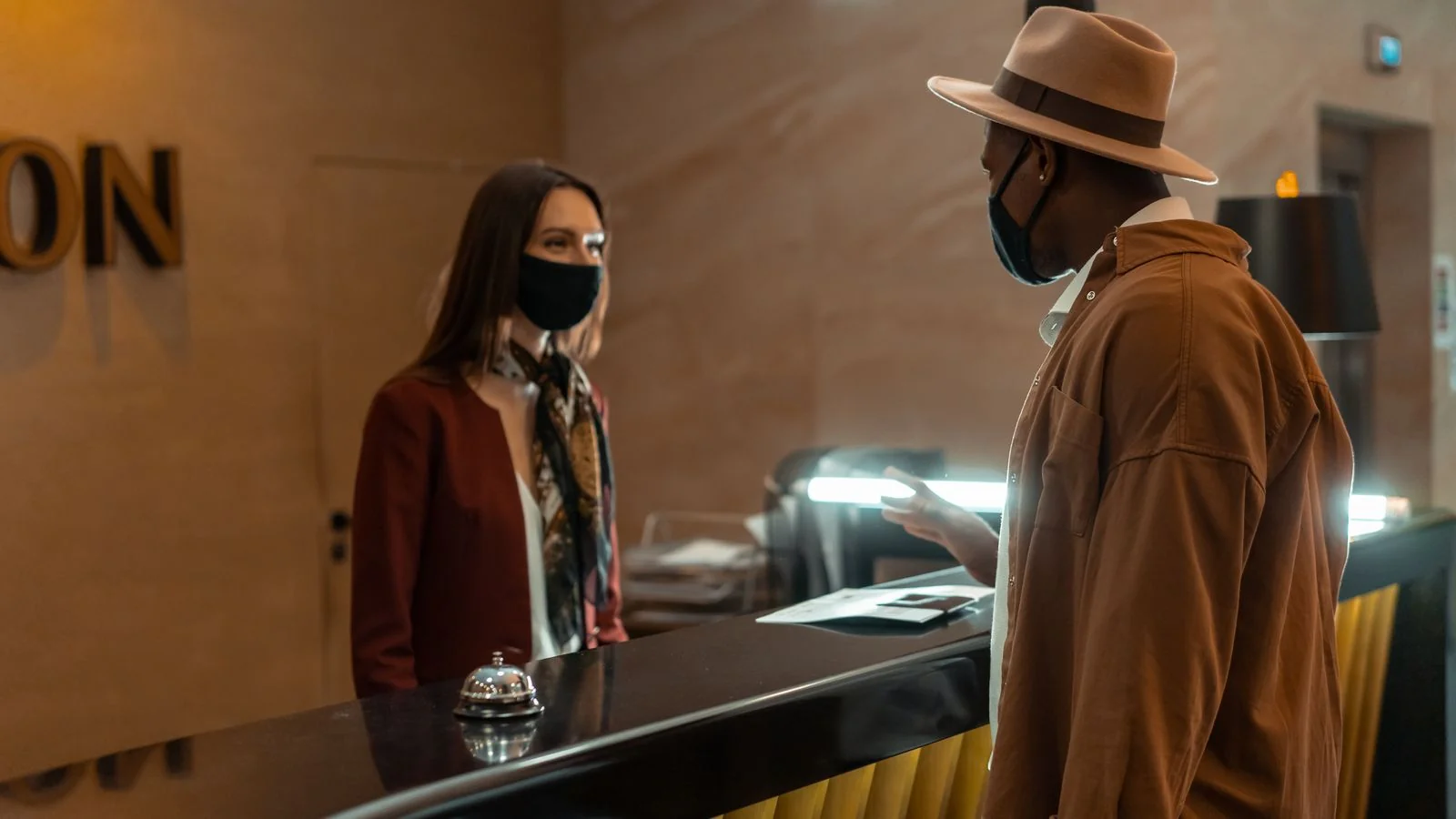 A guest speaking with a staff member at the front desk, where most review problems are either solved or created.
