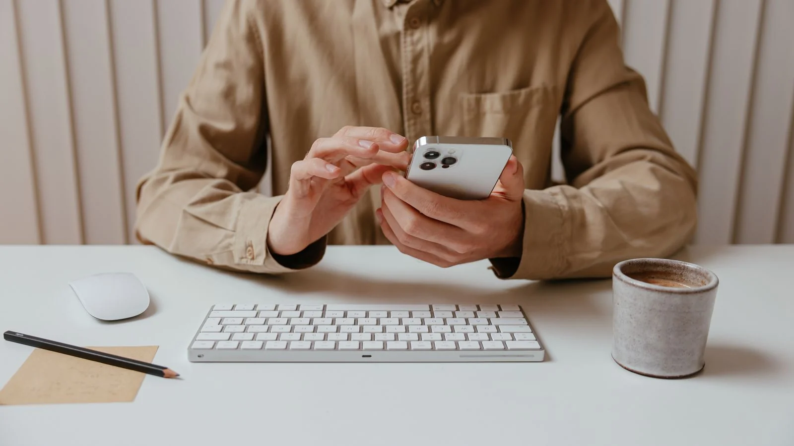 A person typing a review on their phone while sitting at a bar.