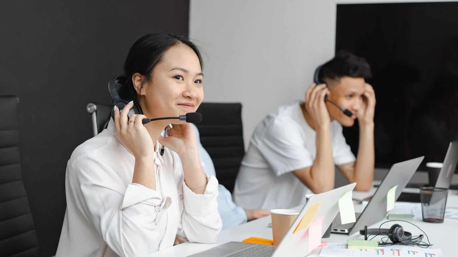 Support agents in headsets at a row of laptops, the team that turns a failed session into a resolved one.