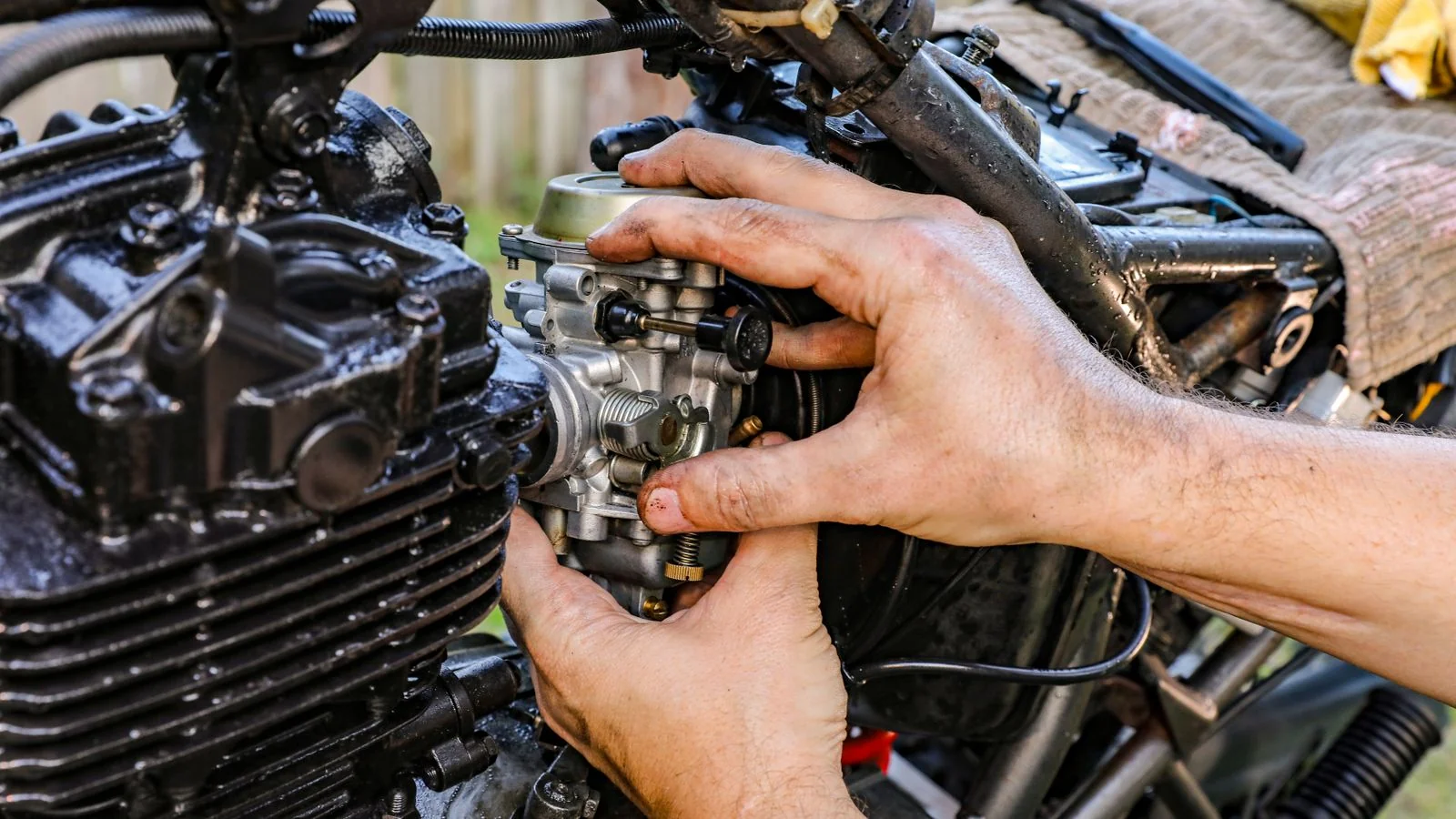 A technician's hands assembling parts outdoors, the craft customers judge in reviews.