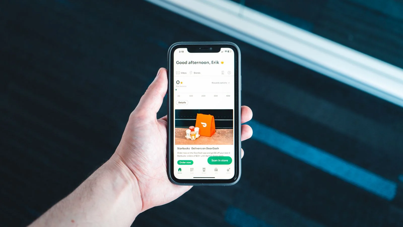A hand holding a phone with an app open on screen, the first place most prospects check