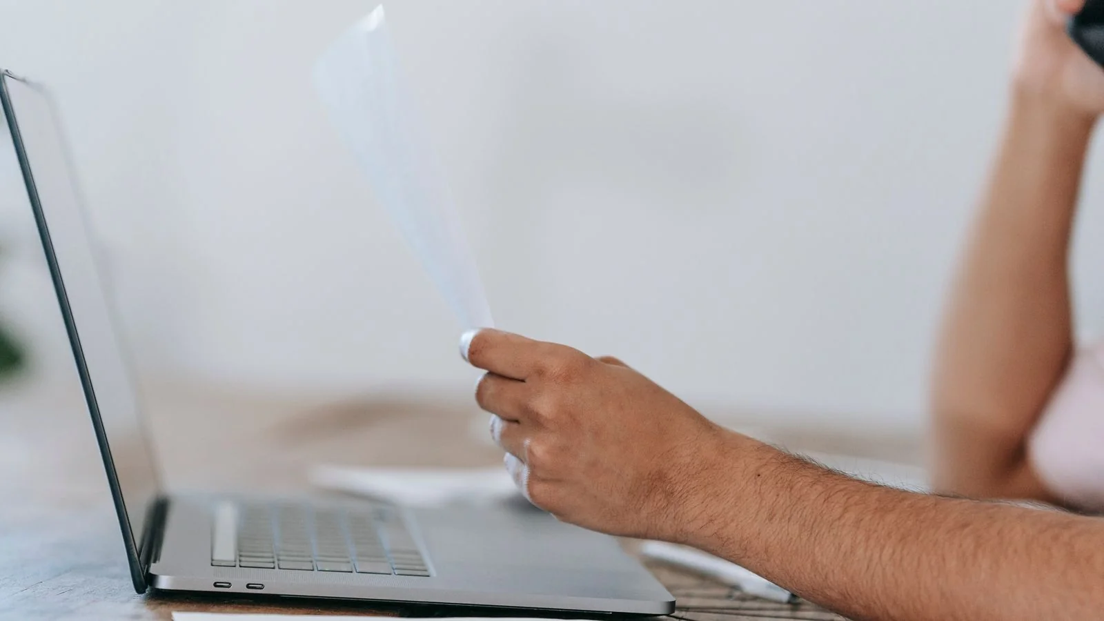 A person reading online reviews on a laptop.