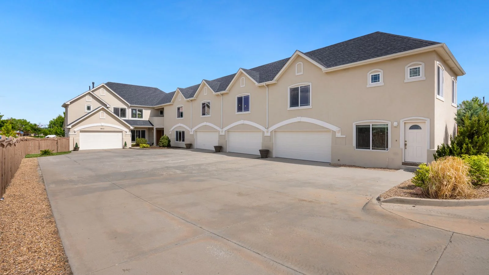 A suburban home with a wide new driveway, the finished job every paving review is really judging.
