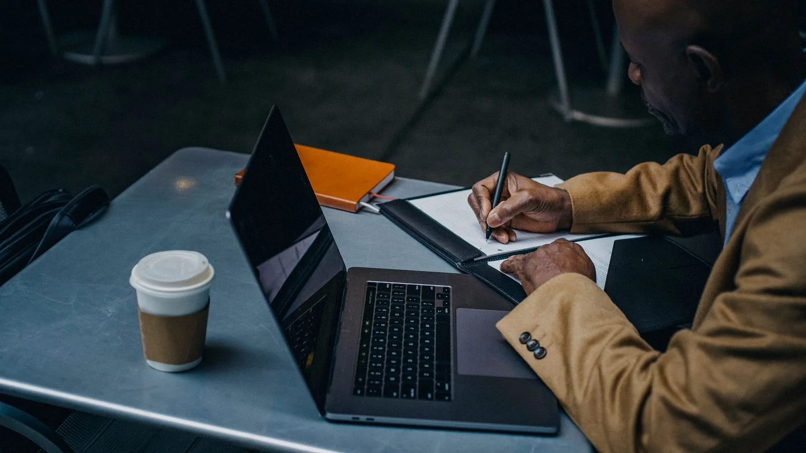 Someone at a laptop writing up notes, the customer leaving the review that shapes your rating.