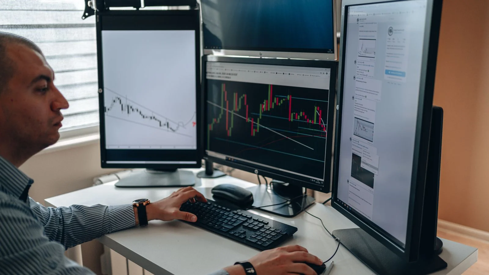 A professional at a multi-monitor desk analyzing charts, the deliberate review that turns raw mentions into decisions