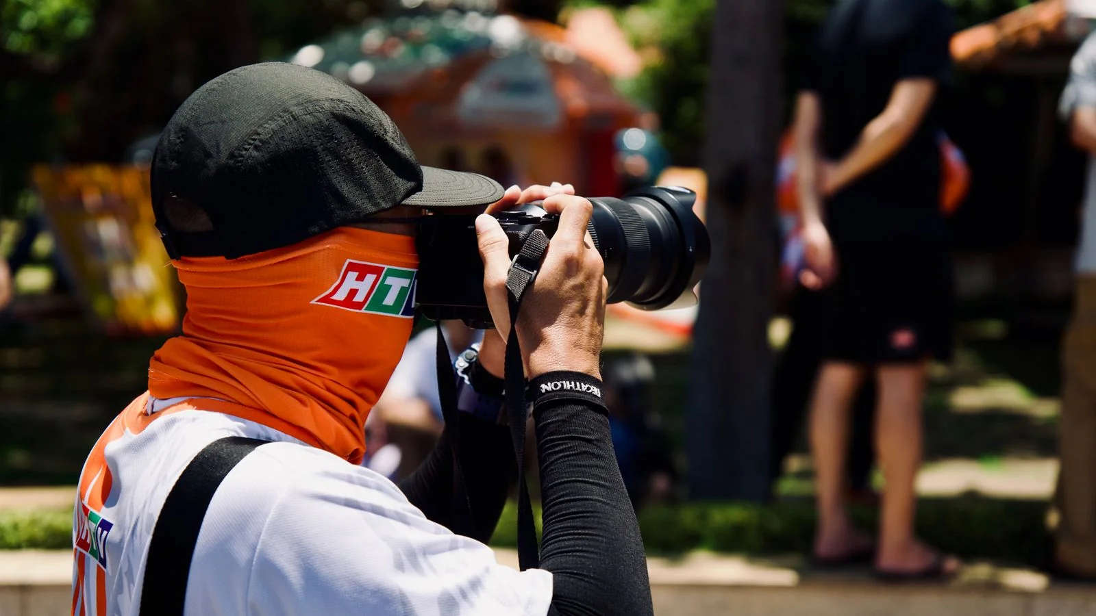 Photographer with a DSLR camera capturing an outdoor community event