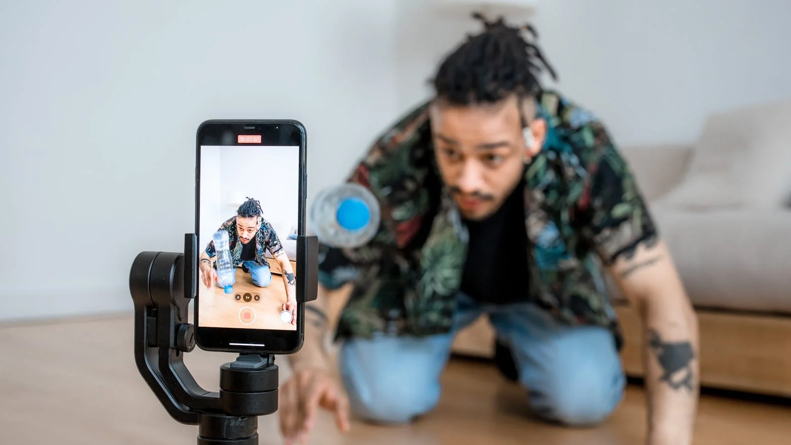 A creator filming content on a smartphone gimbal, one way brands feed visual platforms.