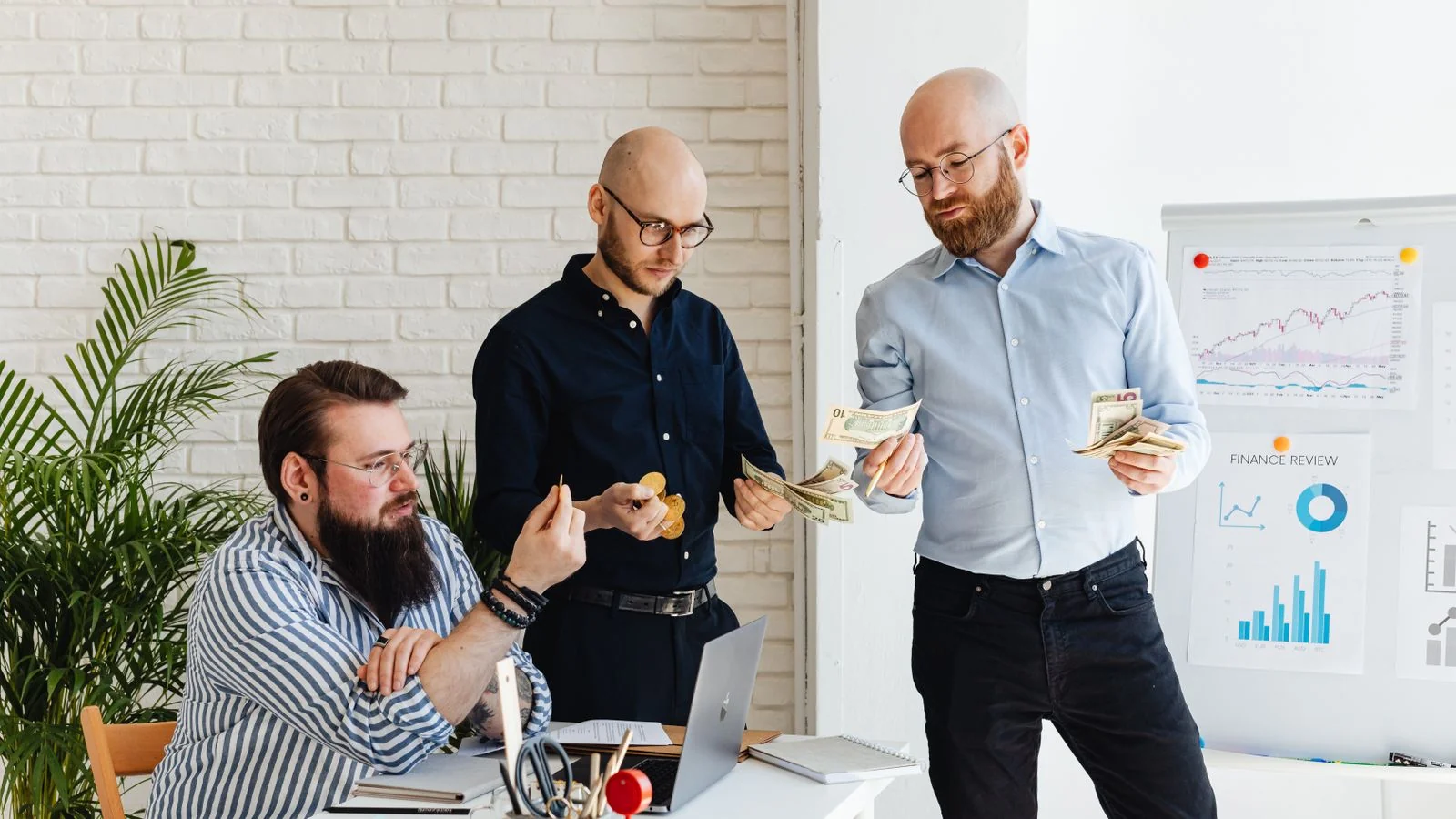 Three colleagues reviewing figures together, the budget conversation this choice usually sits inside