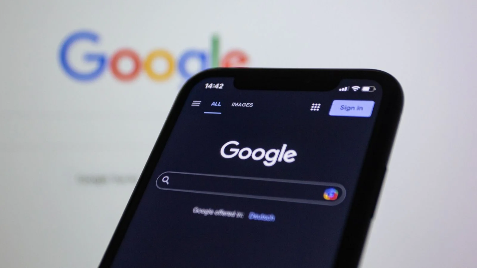 Hands typing on a laptop, pulling up the third-party sites an AI engine actually reads