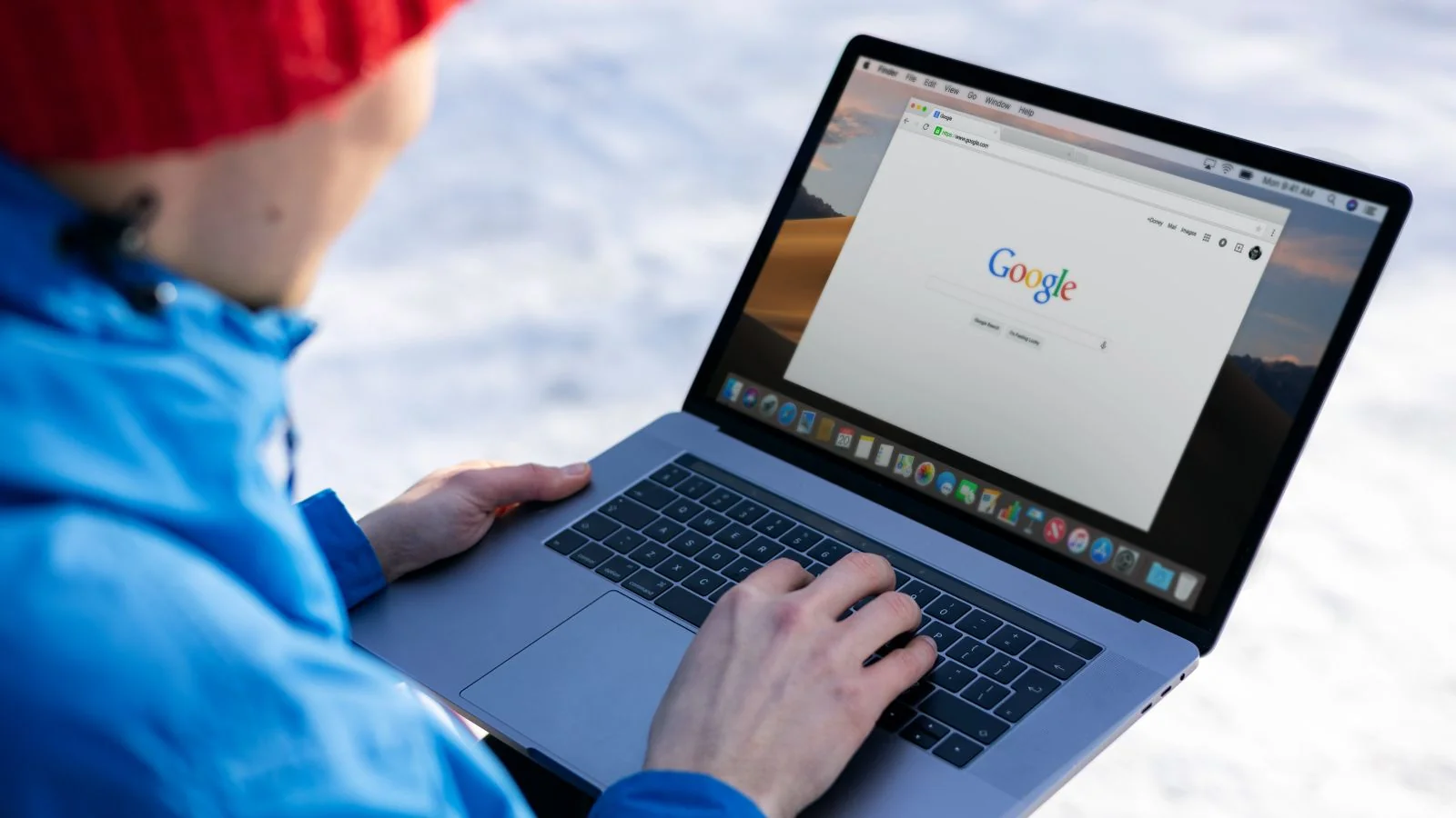 Person running a search query and reading synthesized results on a laptop