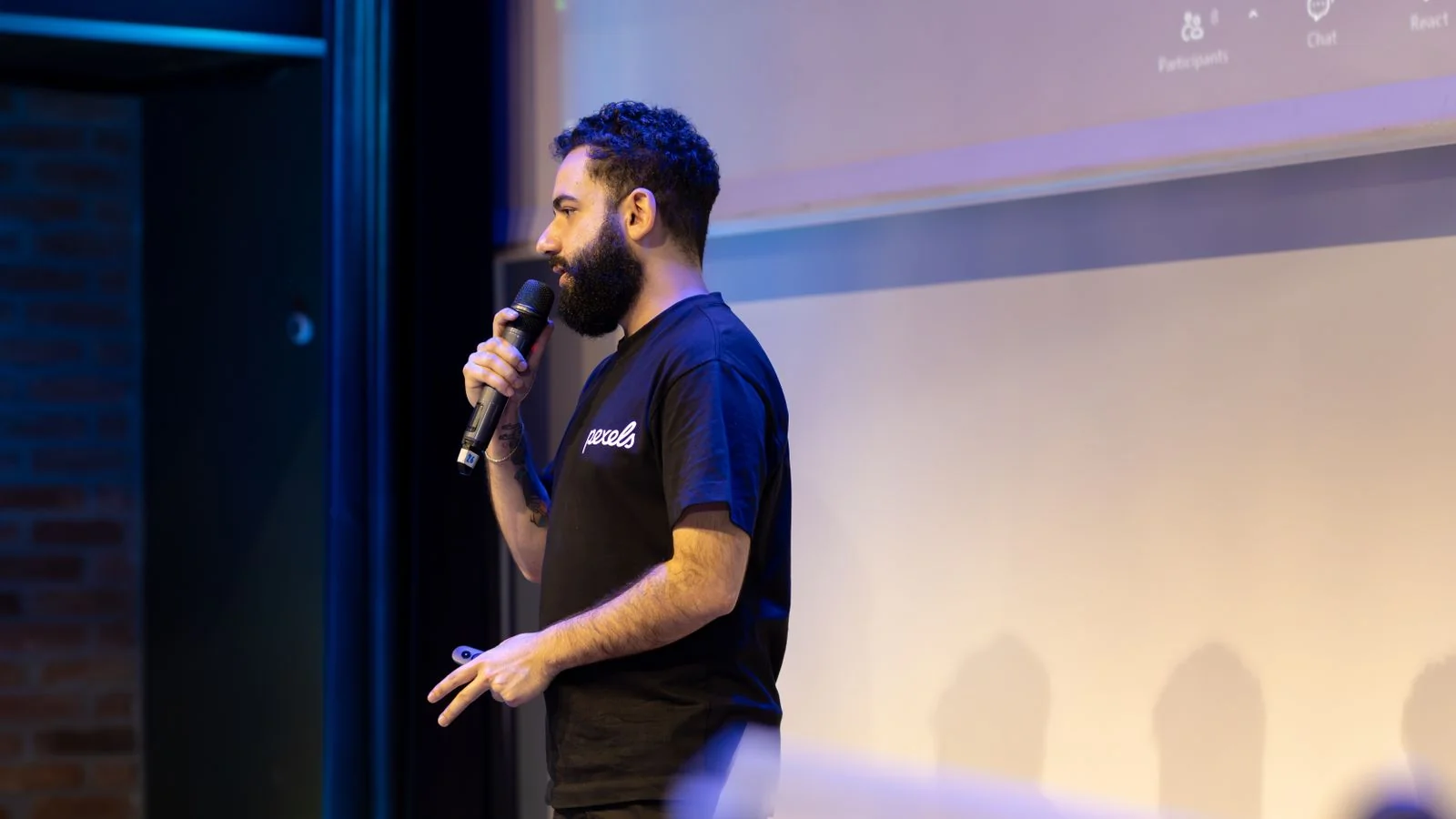 Founder speaking on stage to an engaged audience at a conference