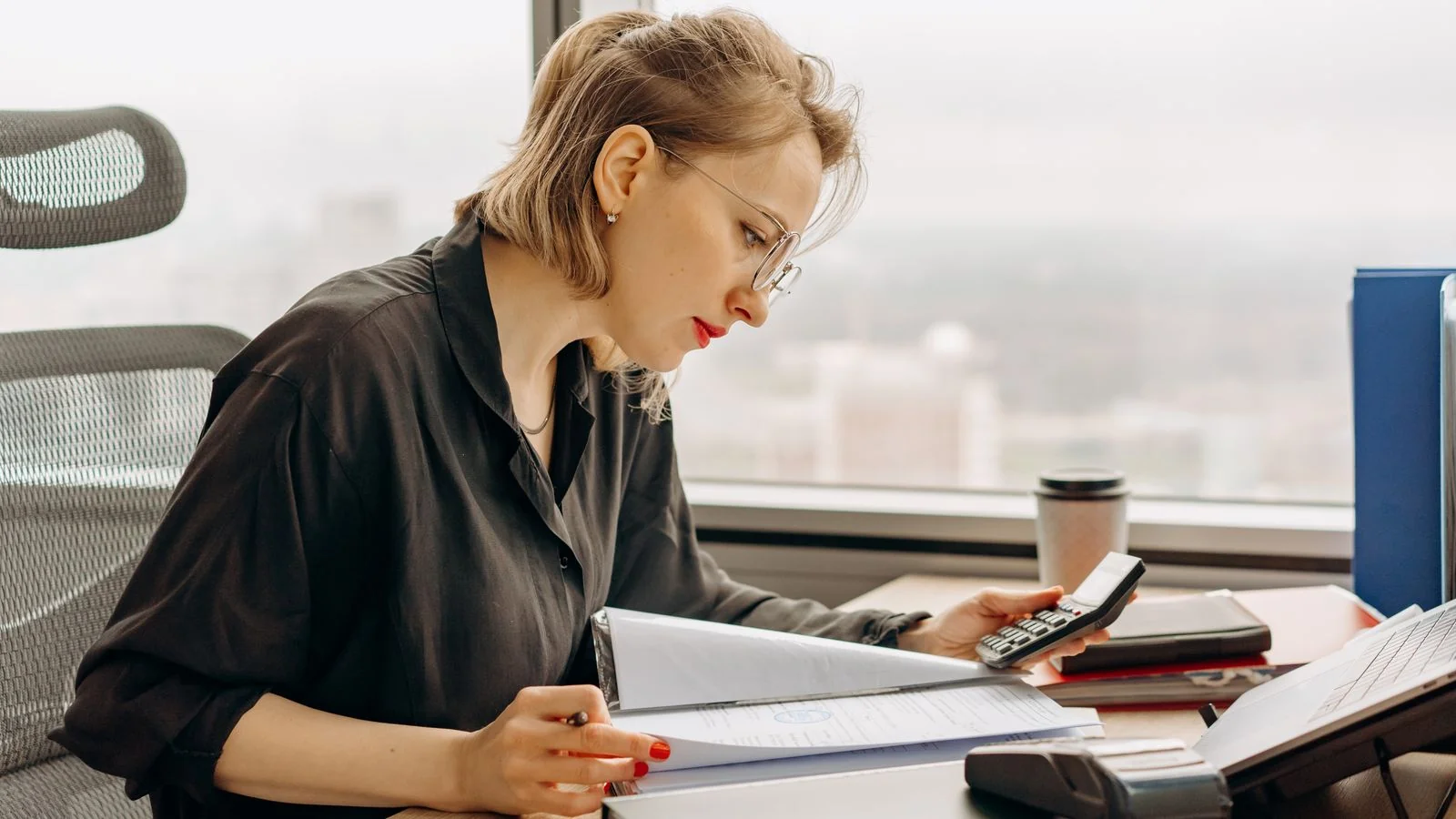 An accountant analyzing detailed spreadsheets on a computer screen.