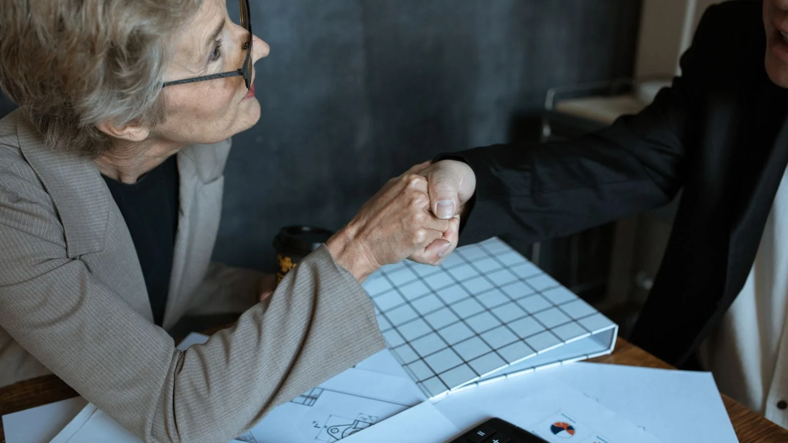 A small business owner meeting an advisor across a table.