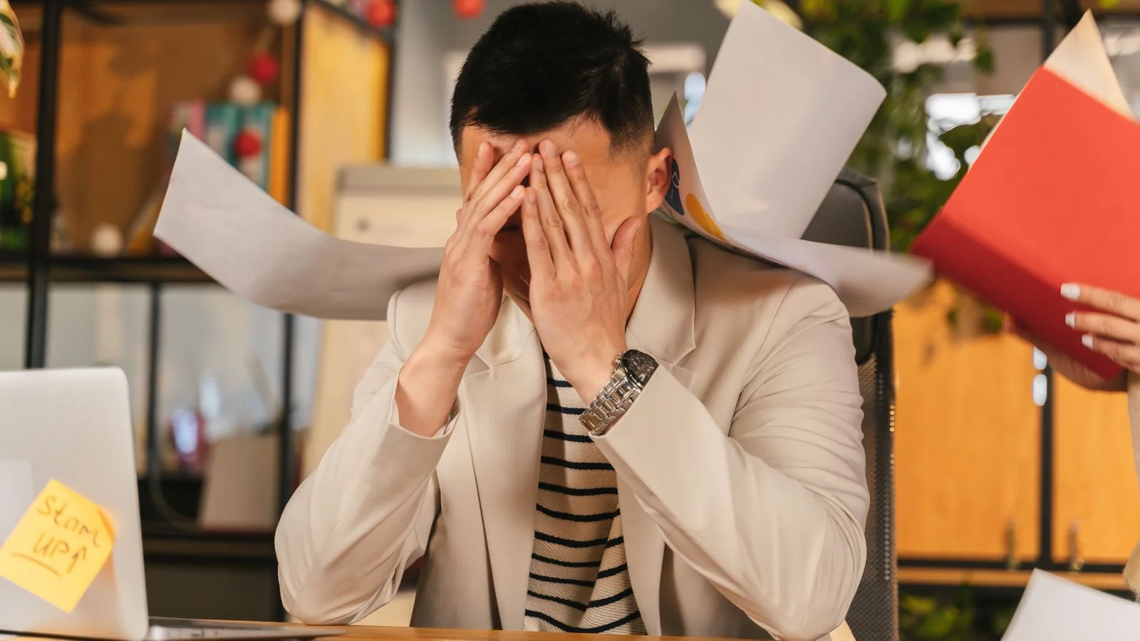 A businessman buried in paperwork, the client state float centres describe in the vaguest possible terms