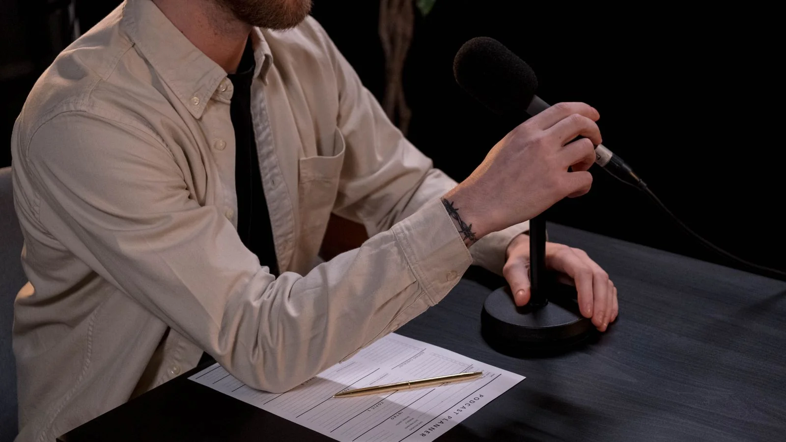 A man setting up a microphone for a podcast recording, the format where float operators can hold a position out loud
