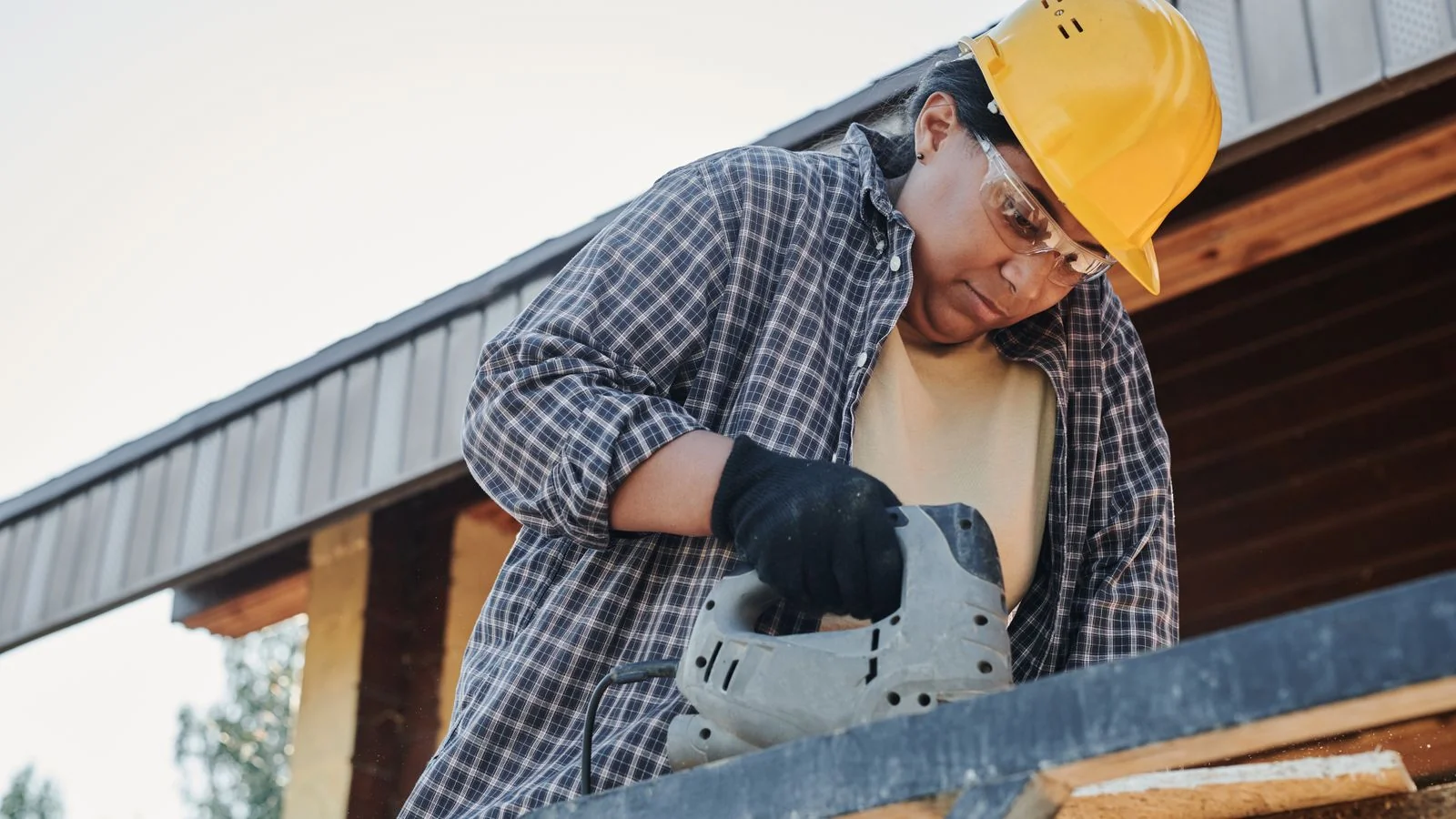 A carpenter operating a circular saw on site, the daily work that generates cost data nobody else collects.