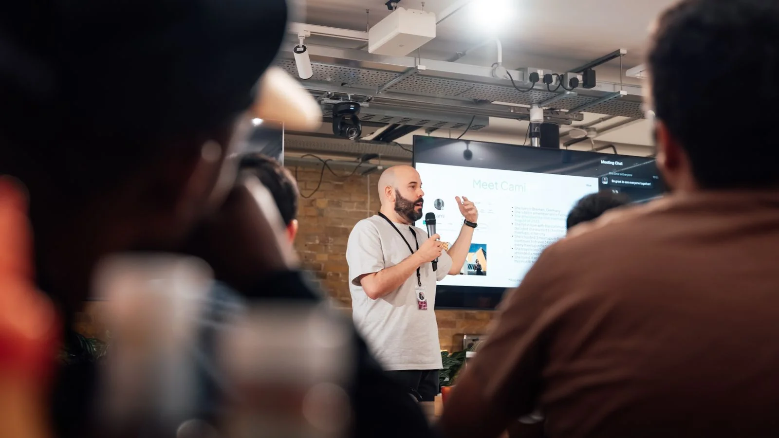A speaker addressing an attentive audience, the visible act of leading a trade's conversation.