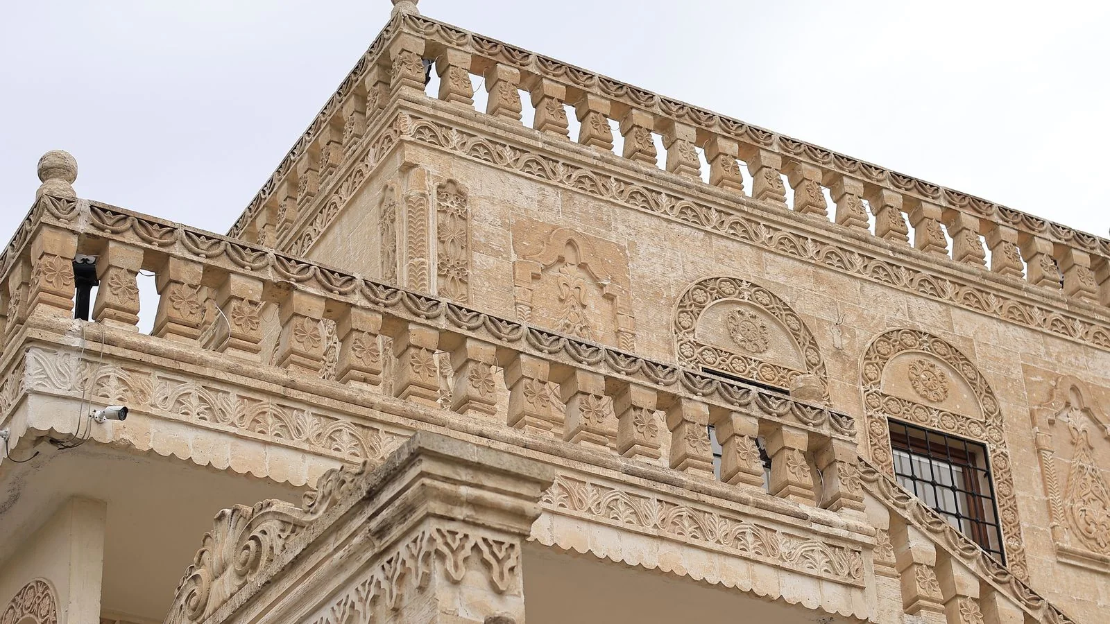 Intricate carved stonework on a building facade, the standard a masonry authority defines and defends.