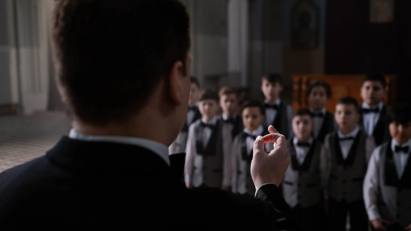 A teacher conducting a small group of young musicians