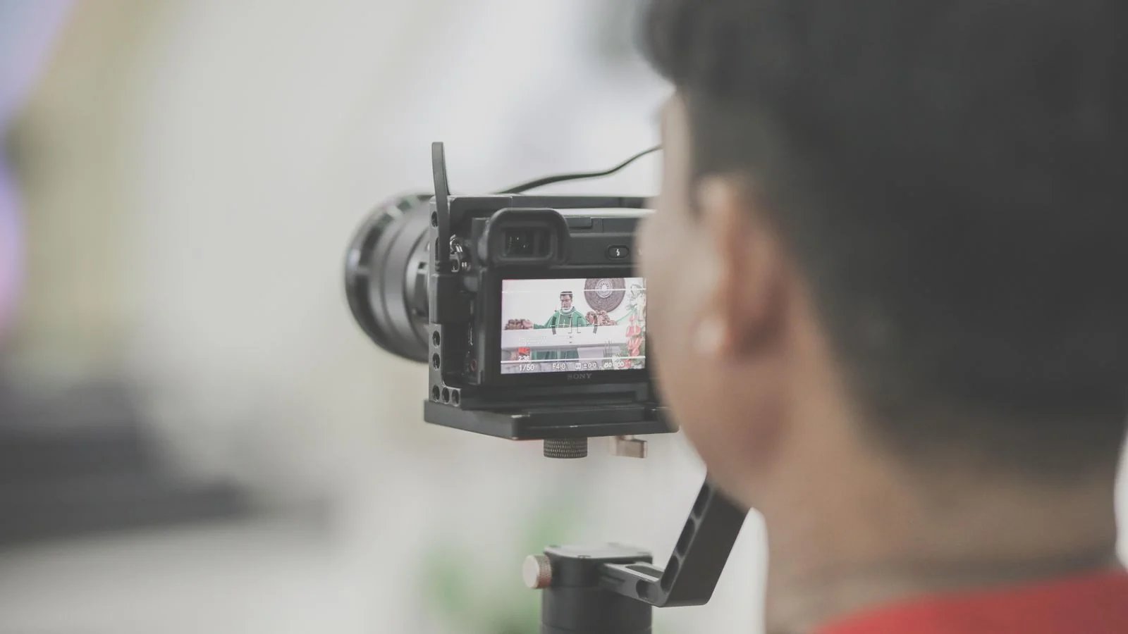 An optometrist films a short explainer video on a camera setup in the practice.